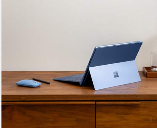 A Microsoft Modern Mobile Mouse pairs with a Surface Pro 9 and a Surface Type Cover.