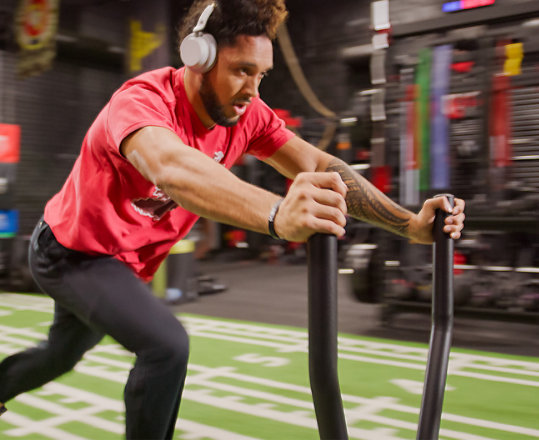 San Francisco 49er Talanoa Hufanga works out while wearing Surface Headphones 2.