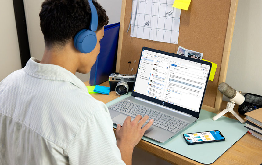 A college student uses Outlook on his laptop. 