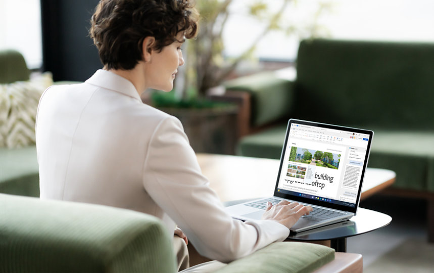 A person sitting on sofa collaborating on a Surface Laptop.