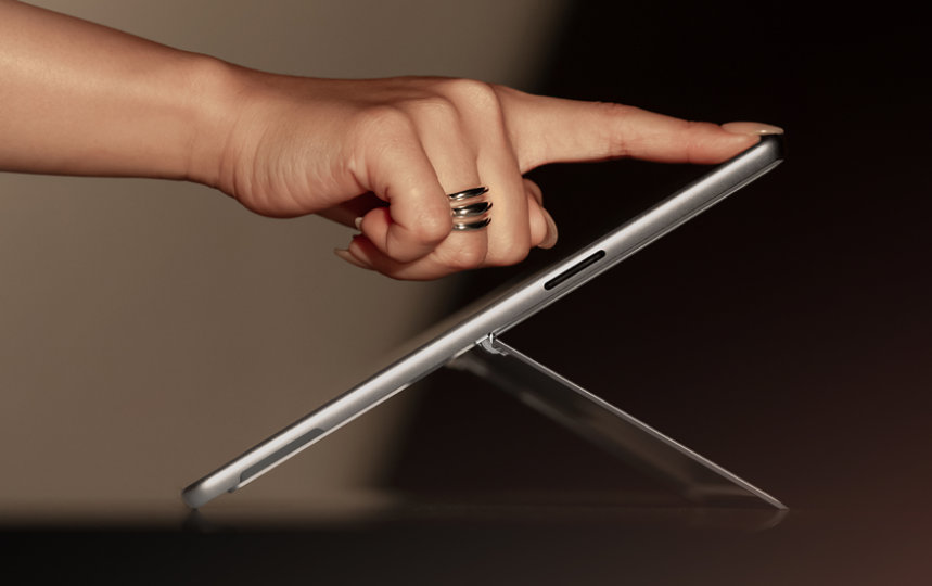 A close-up of a person interacting with the touchscreen of a Surface Pro for Business.