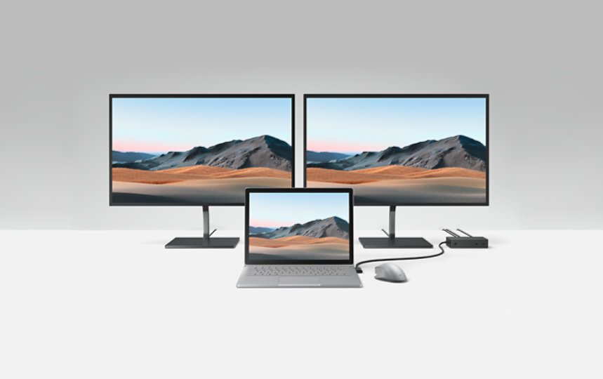 Multiple monitors and a laptop connected to Surface Dock 2.