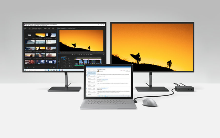 Multiple monitors and a laptop connected to Surface Dock 2 for Business.