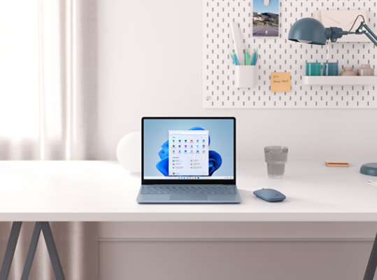 Ice Blue Surface Laptop Go on a desk.