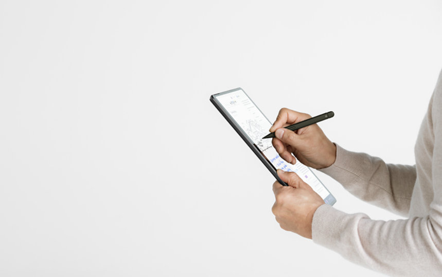 A person uses a Surface Pen to write on the touchscreen of a Surface Pro 10 for Business.