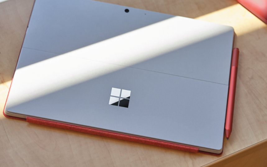 Surface Pen in Poppy Red magnetically attached to a Surface device.