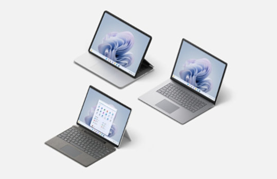 A Surface Pro 9 with a Typecover in Platinum, A Surface Laptop Studio and a Surface Laptop 5 in Platinum.