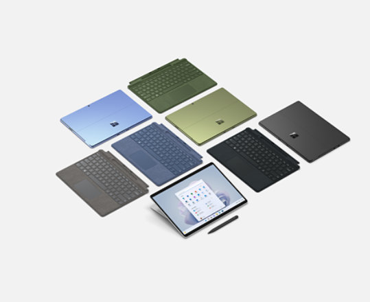 Een assortiment Surface Pro 9-apparaten en Surface Pro-toetsenborden in verschillende kleuren.