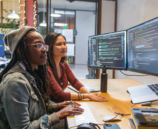 Coworkers use Visual Studio on multiple desktop monitors at work.