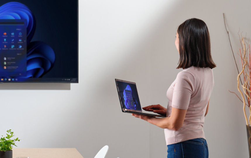 Woman using a Windows 11 computer in a conference room at work.