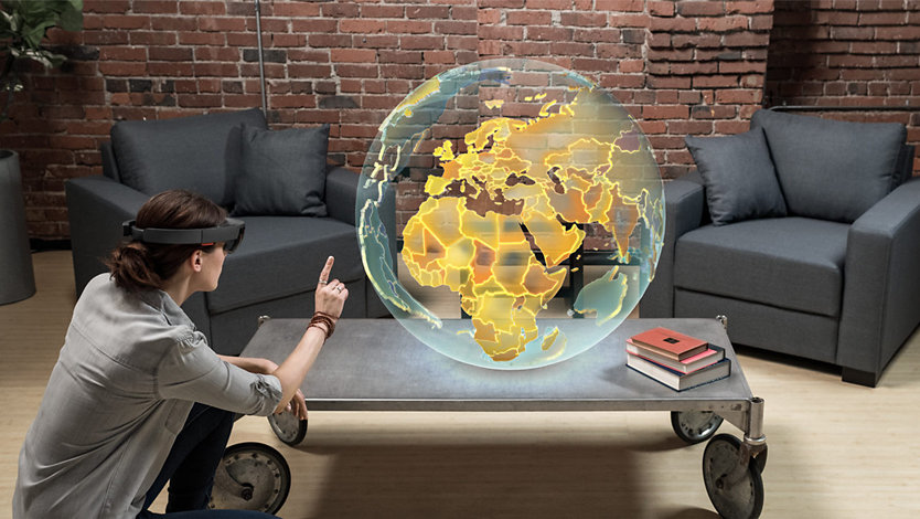 Woman using HoloLens to interact with the globe