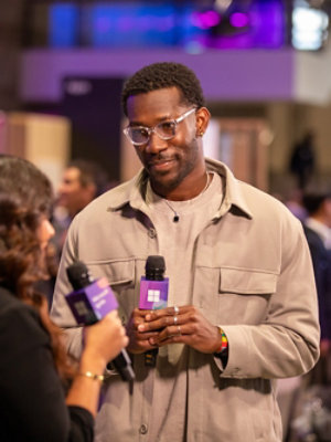 A person using a stylus on a tablet at a desk.