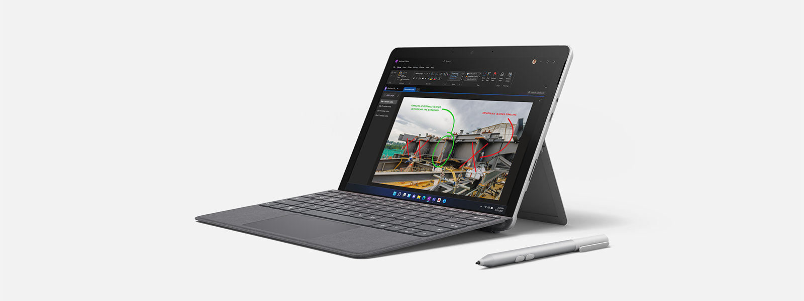 Microsoft Business Pen beside a Surface Go device with notes sketched on the screen. 