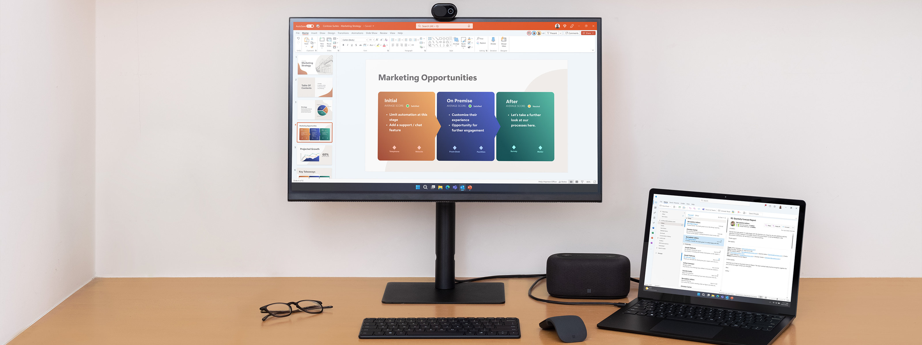 A desktop setup shows Microsoft Audio Dock alongside other Surface products.