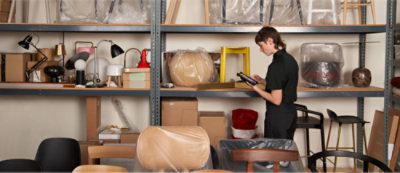 A person looking at a tablet in a furniture store.
