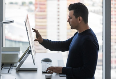 A person working in an office at a standing desk