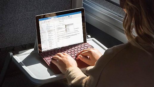 A person using a Surface device on public transportation 