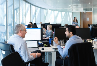 Two people conferring at a desk