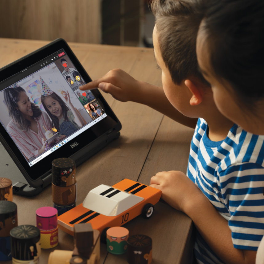 A mother and child using a tablet to participate in a video call with other children and parents.