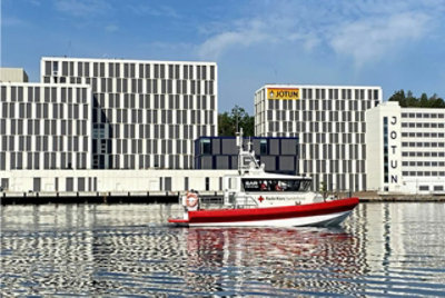 A boat floating outside of the Jotun headquarters