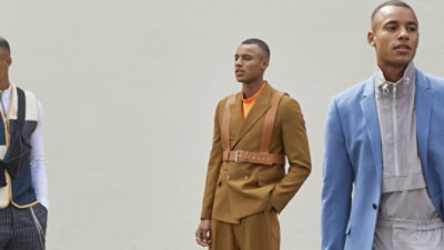 A man in a tan suit is standing next to a man in a blue suit.