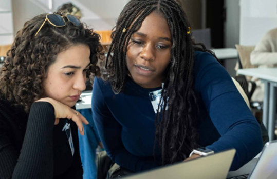 Two women using a computer