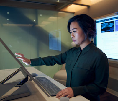 Woman working on her touch screen laptop