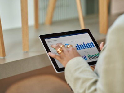 Tablet displaying analytics dashboard with charts.