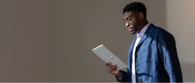 A person holding a white tablet.