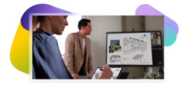 Two people in a conference room on a Teams video call and looking at architectural designs.