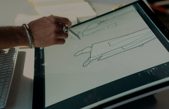 Joey, the fashion designer, sketches an outfit on a Surface screen with the S Pen.