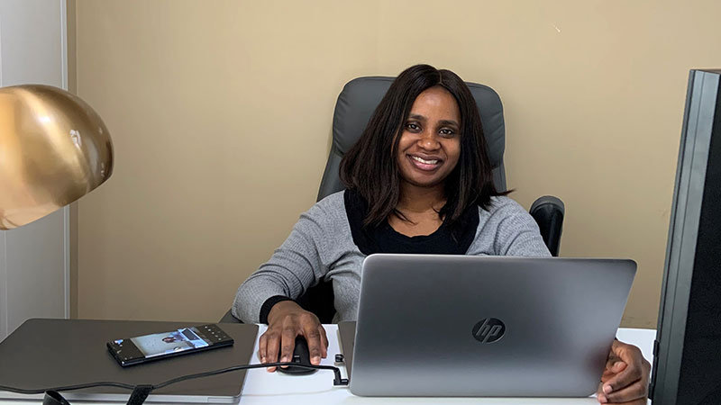 Jumoke Olugbade working at a desk in her home office