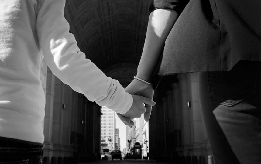 Parent and child holding hands.