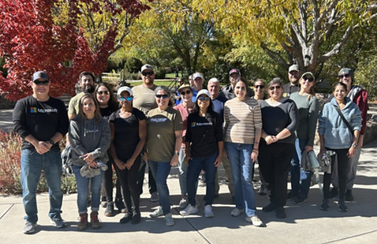 A group of Microsoft Reno Employees standing in front of a park pagoda at Mira Loma Park in Reno, Nevada. 