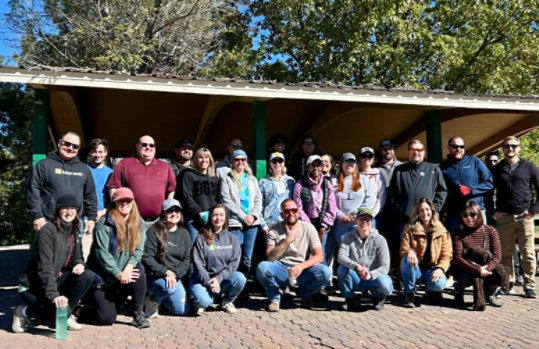 A group of Microsoft Reno Employees standing in front of a park pagoda at Mira Loma Park in Reno, Nevada. 