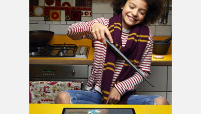 A child uses the wand to unlock a coding challenge.
