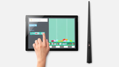 The wand next to a Surface tablet with coding challenge onscreen.