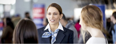 Three girls are standing and talking with each other