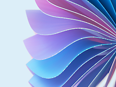 Abstract image featuring a spiraling arrangement of layered petal-like shapes in shades of blue and purple