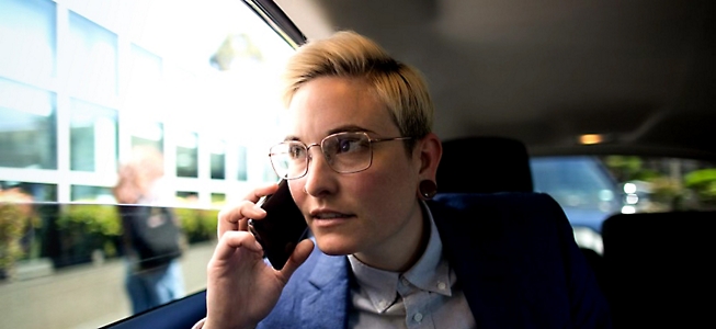 A woman in glasses talking on a cell phone.