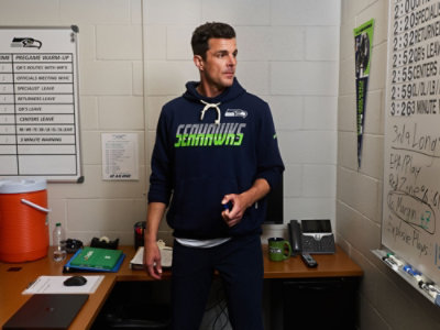 Person wearing a navy-blue Seattle Seahawks hoodie