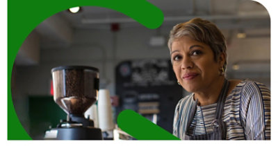 A coffee shop employee smiling.