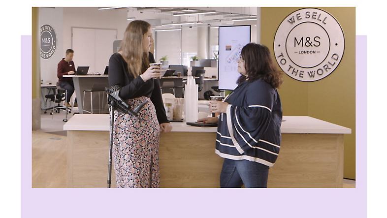 Two employees having a conversation over coffee in the Marks & Spencer office