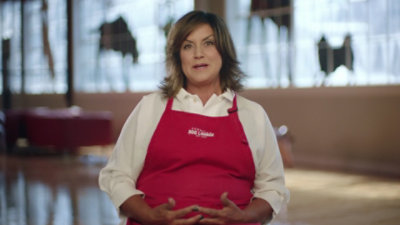 A person wearing a red apron
