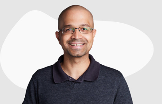 A man with glass on a grey background