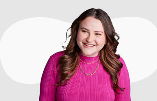 A girl on a grey background behind her