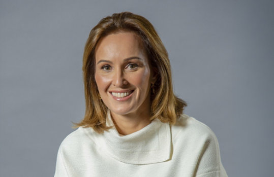 Pessoa com suéter branco em fundo cinza