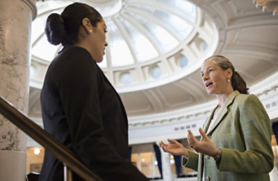 Two people speaking in a government building 