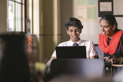 A group of business people working together on a laptop