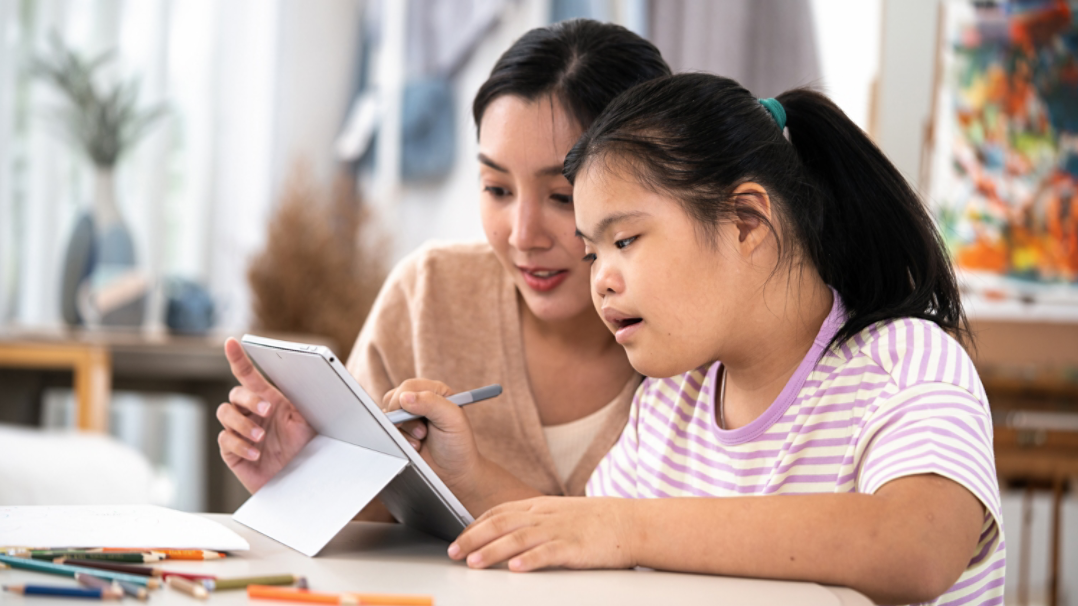 Professional female psychologist working with a girl with Autism in her office.